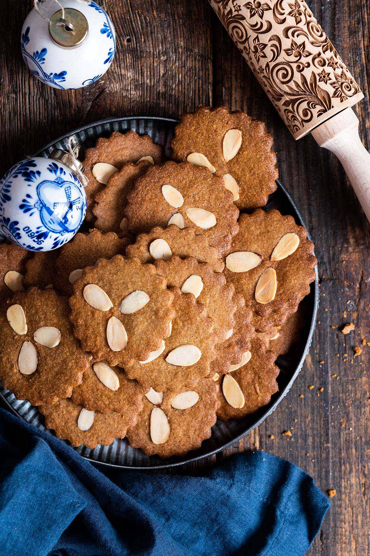 top view of Speculaas cookies on plate on rustic wooden table