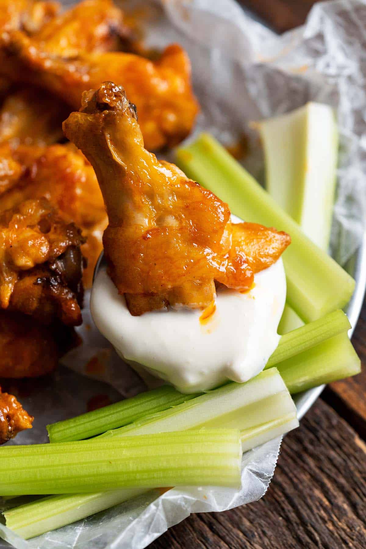 dipping crispy chicken wing in blue cheese