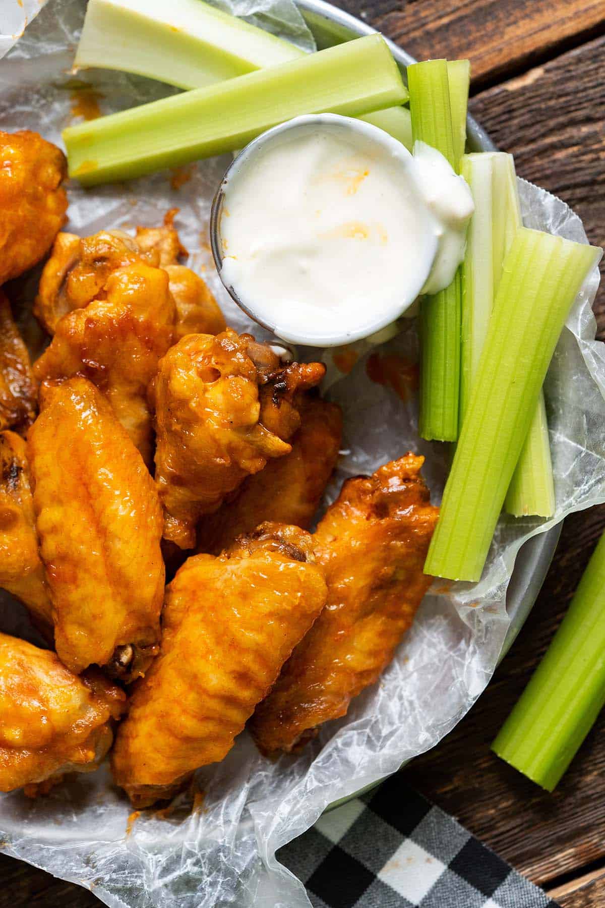 plate of crispy air fryer chicken wings with buffalo sauce and blue cheese dip