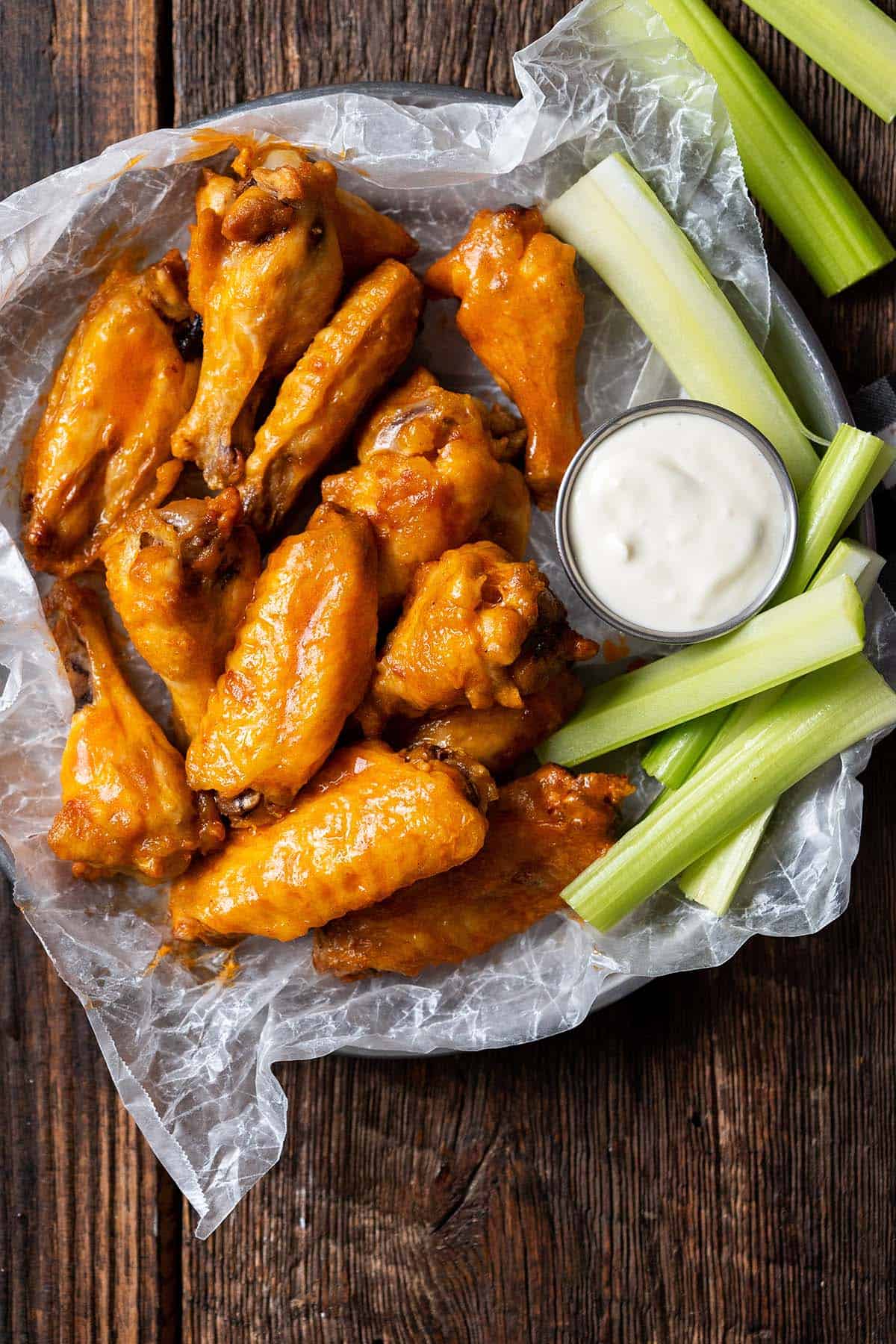 platter of wings with buffalo sauce and celery