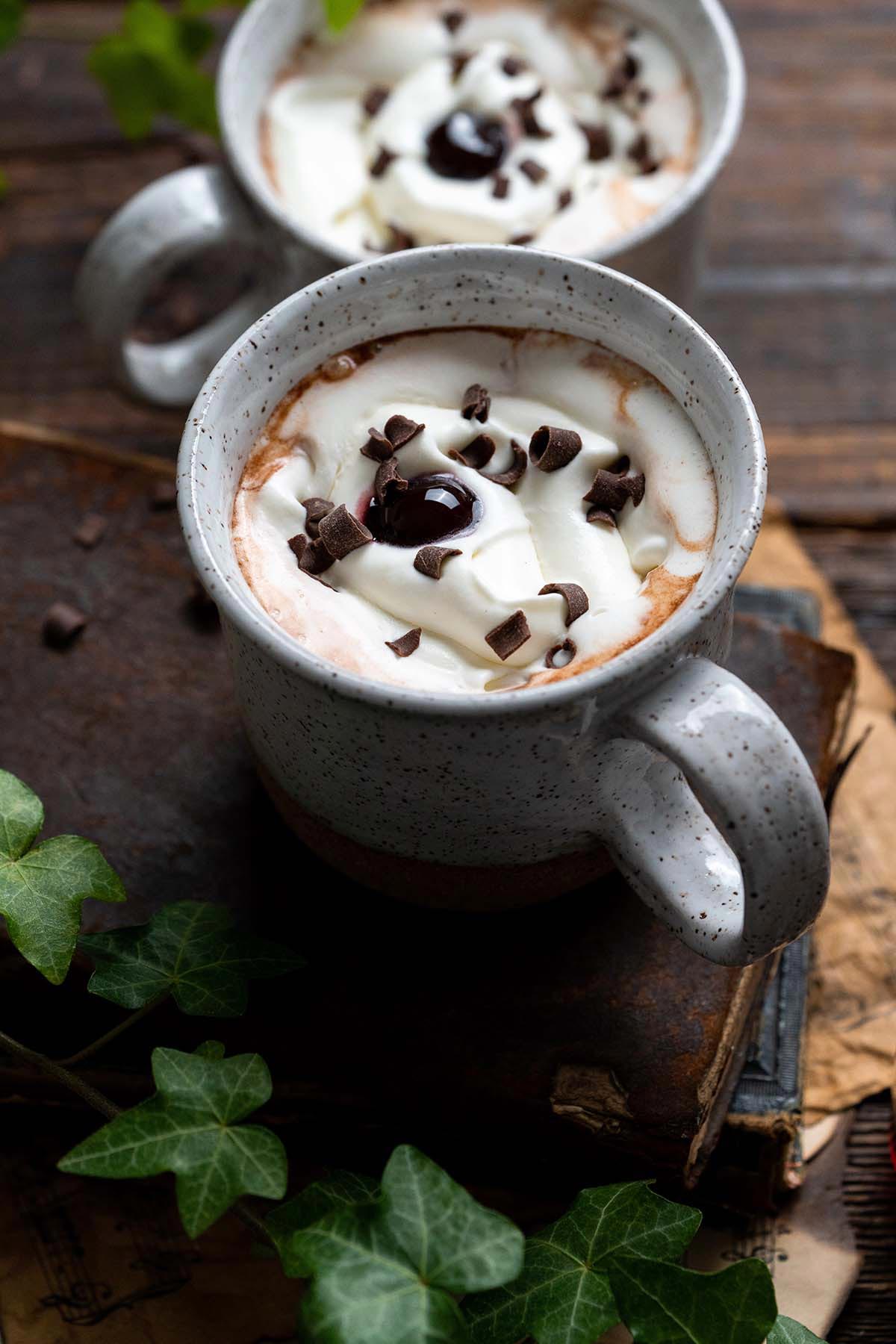 white ceramic mug with cherry hot chocolate