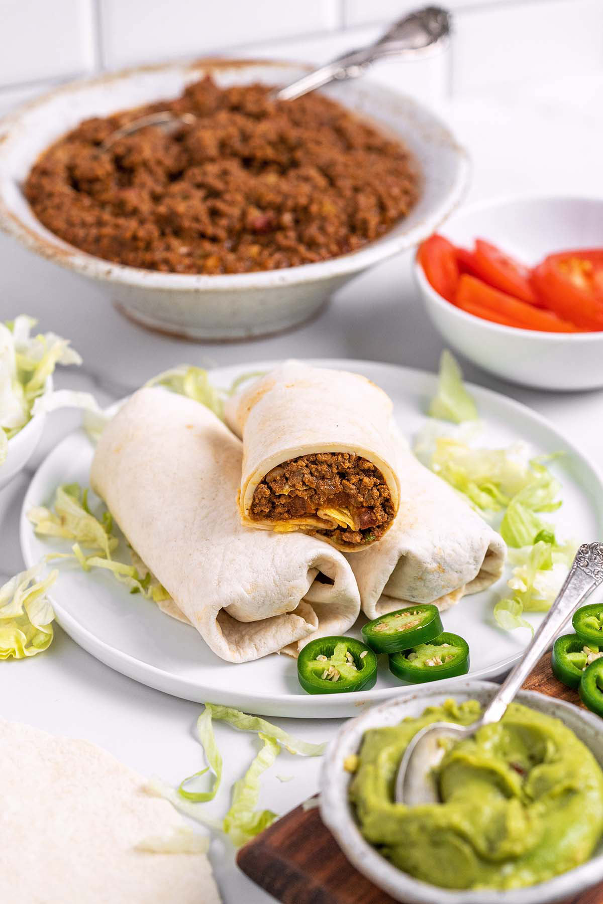 ground beef tacos on plate with components around