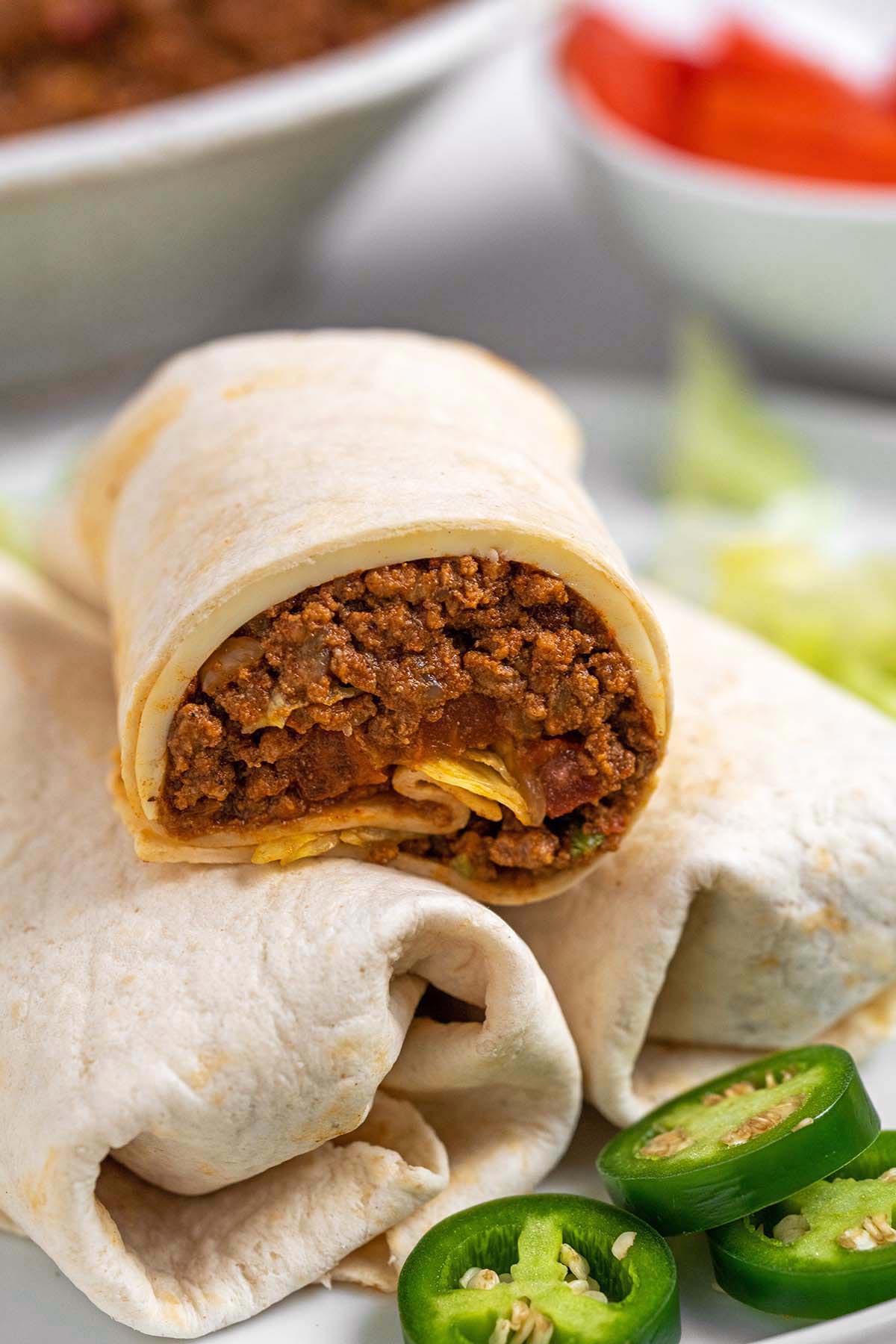 stack of tacos with copycat mighty taco meat with top cone cut in half to show taco filling