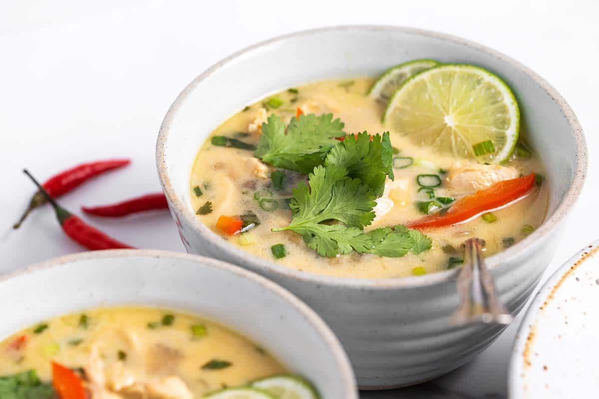 bowls of creamy coconut thai soup with chicken