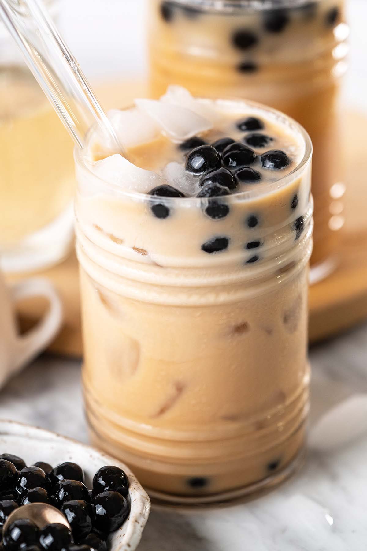 close up of boba milk tea with black tapioca pearls