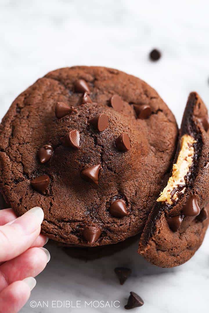 stack of chocolate peanut butter cookies with hand reaching in