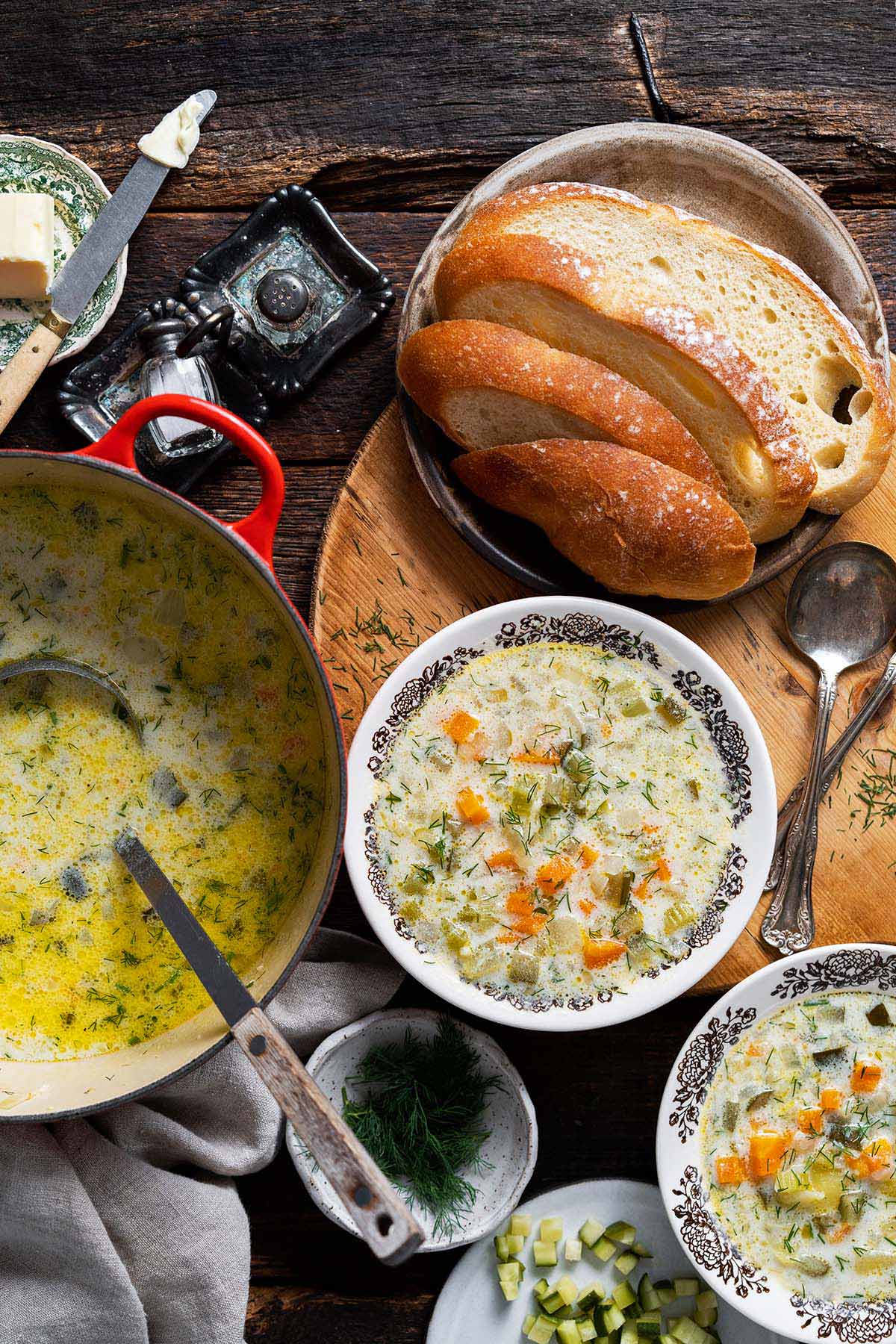 table spread of polish dill pickle soup with sour cream and sourdough bread