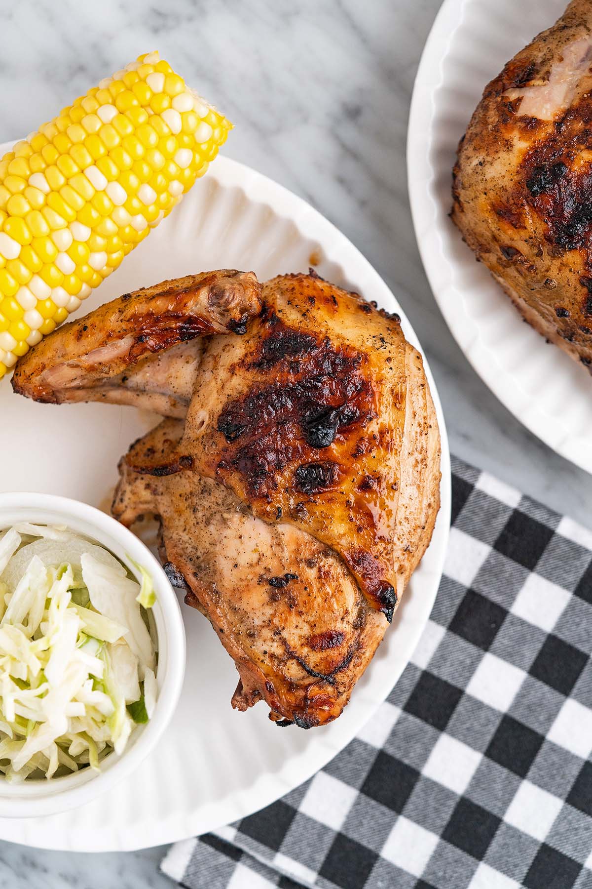 chiavetta's barbecue chicken on plate with coleslaw and corn on cob