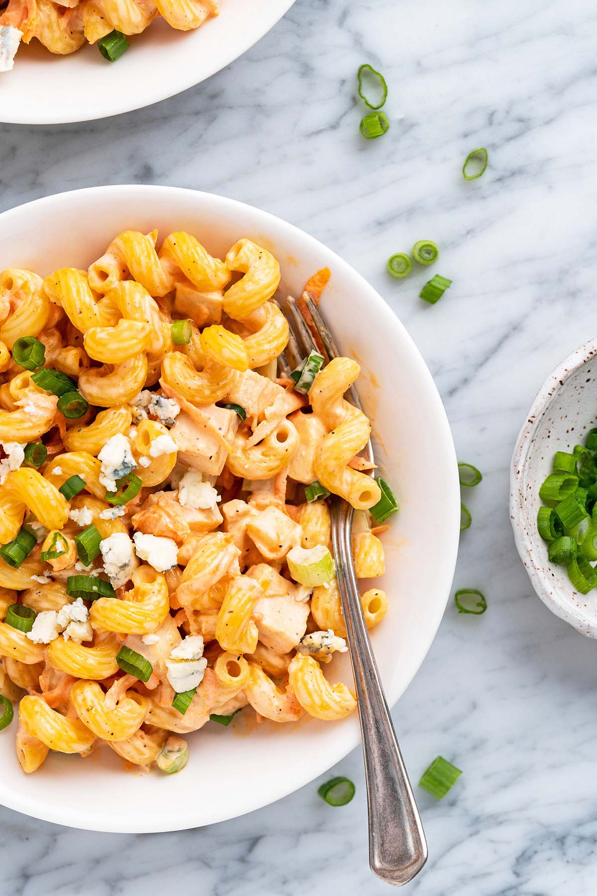 close up top view of bowls of cold buffalo chicken pasta