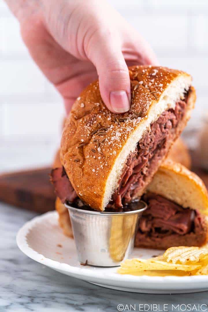 dipping beef sandwich in au jus