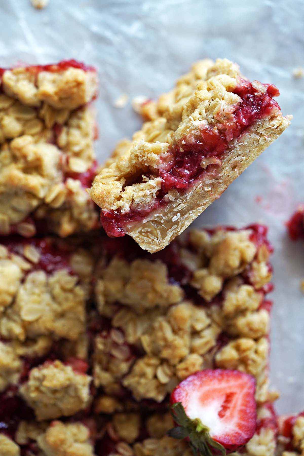 overheat view of strawberry crumb bars with oats on parchment paper