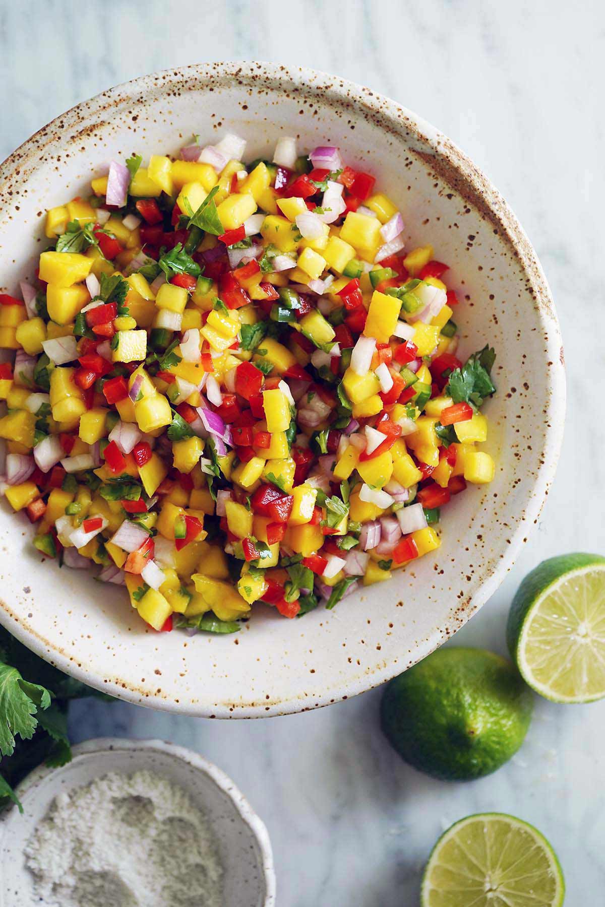 top view of fresh mango salsa with lime in bowl