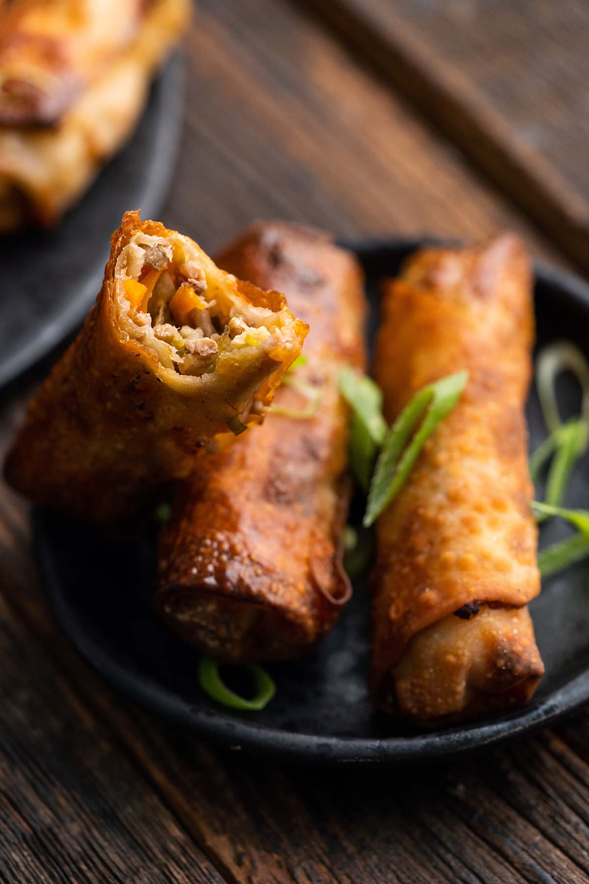 appetizer plate with egg rolls with bite taken out of one