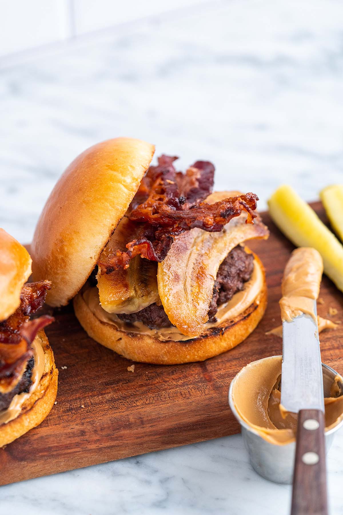 elvis burgers on wooden serving tray on marble countertop