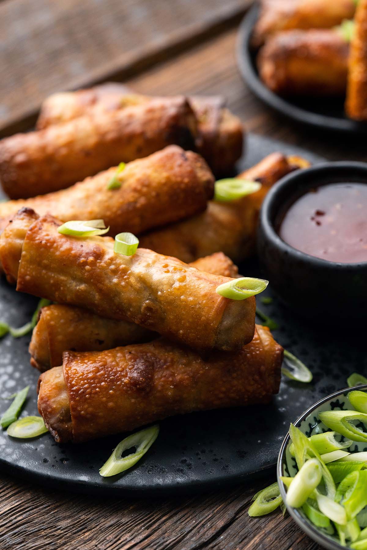 pile of eggrolls with turkey vegetable filling on black plate