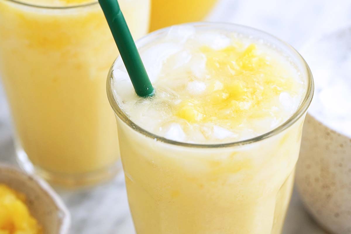 pineapple paradise drink in glass with green straw