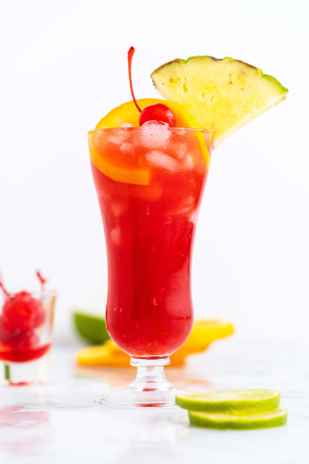 rum runner drink garnished with pineapple orange and maraschino cherry