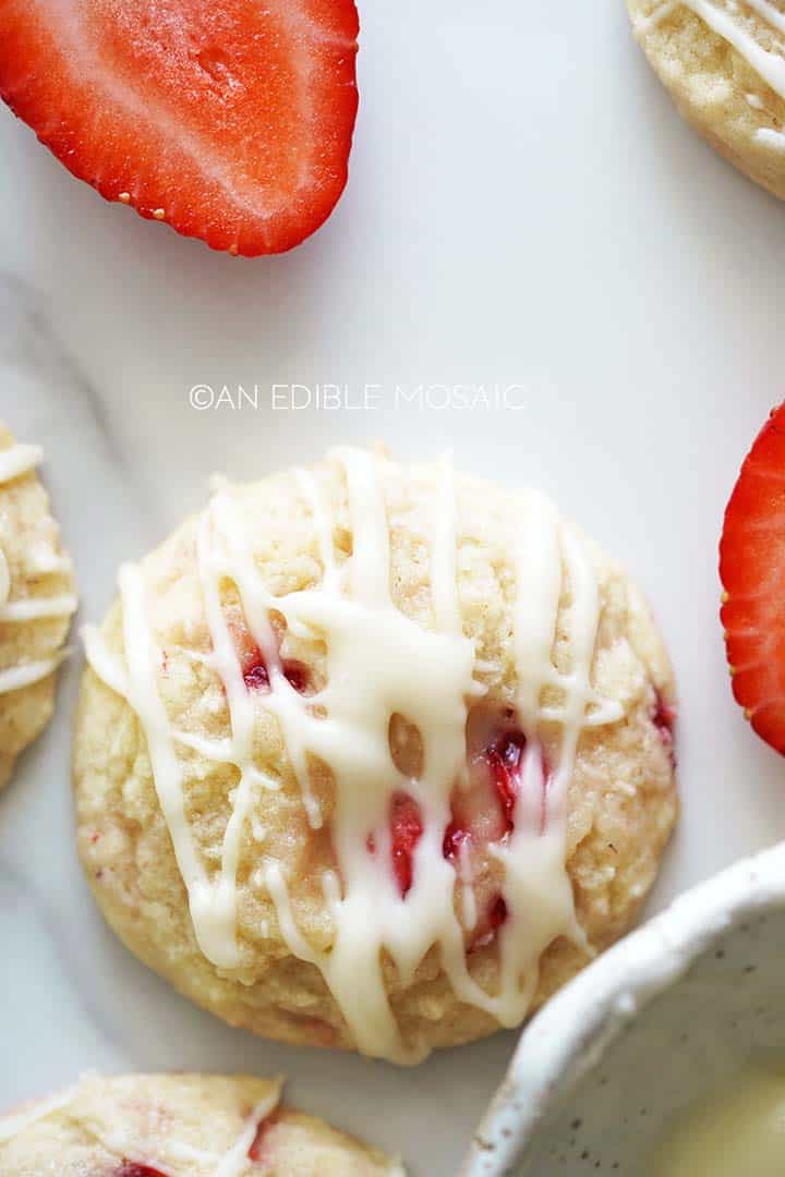 close up top view of strawberry cookie with icing drizzled on top
