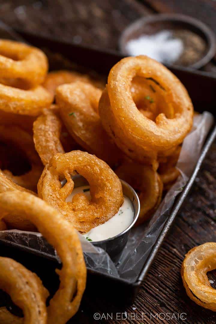 dipping beer battered onion ring in ranch