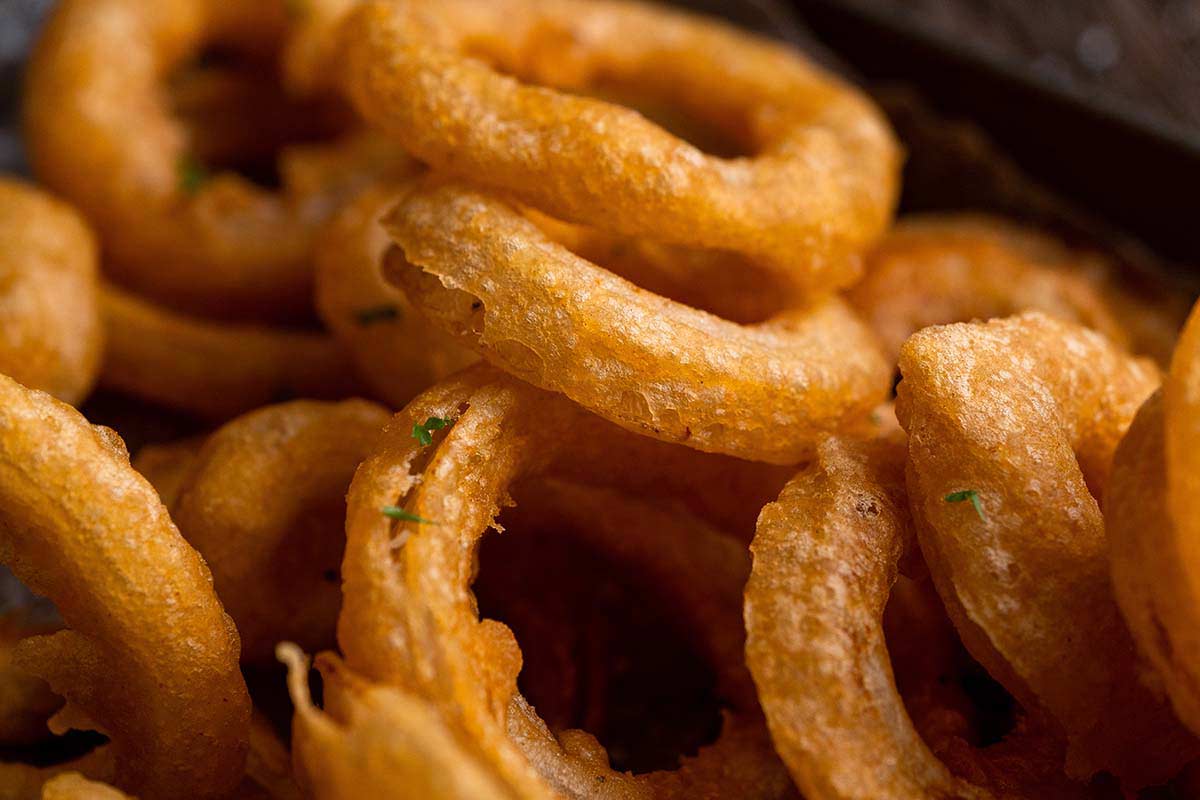 pile of crispy beer batter onion rings