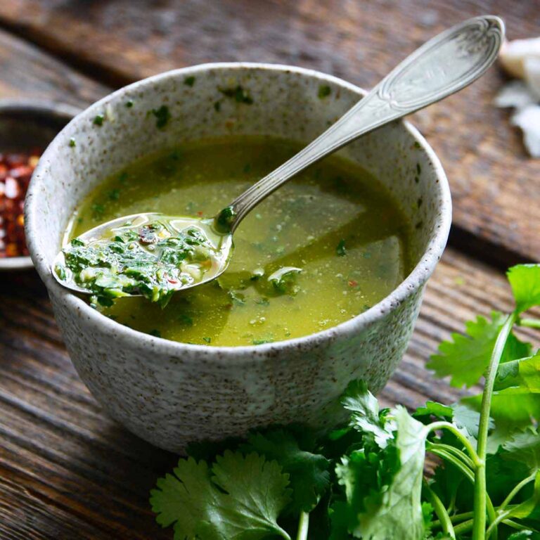 authentic chimichurri recipe in stoneware bowl on dark wooden table