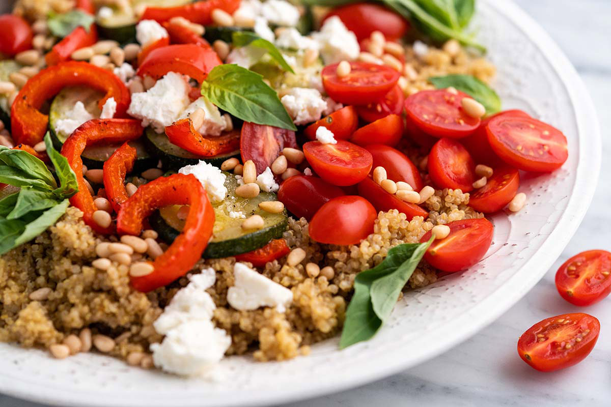 epic roasted vegetable quinoa salad on white serving platter