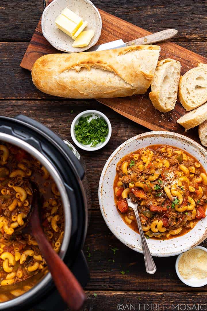spread of goulash in bowl and in instant pot with side of bread