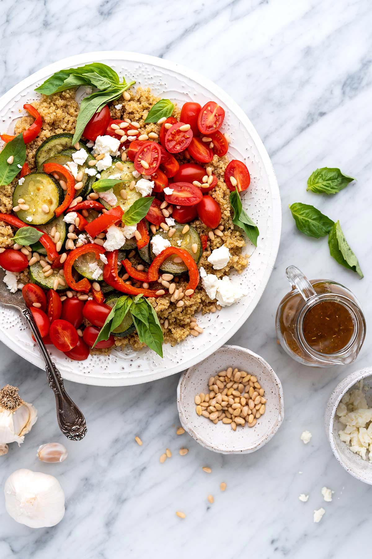 top view of serving platter with mediterranean roasted vegetable quinoa salad recipe with feta and pine nuts