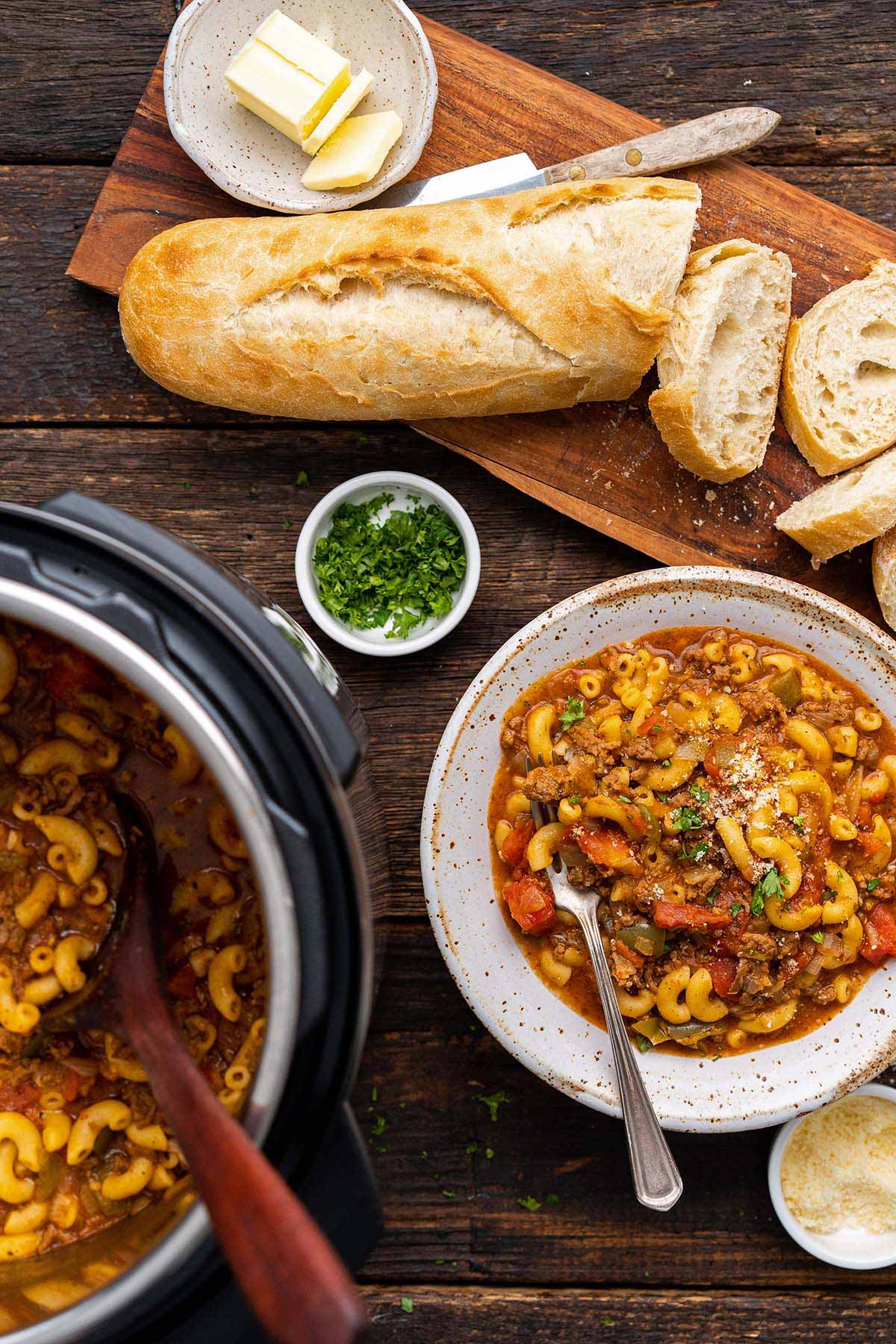 dinner spread of instant pot American goulash made with elbow macaroni on rustic wooden table