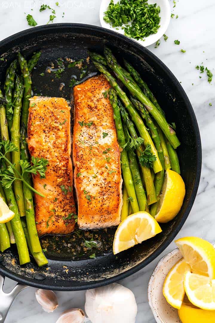 seared salmon with asparagus in skillet