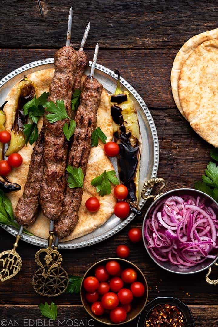spread of turkish lamb kebabs with flatbread and vegetables