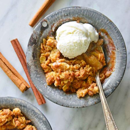 quick and easy air fryer apple crisp topped with vanilla ice cream