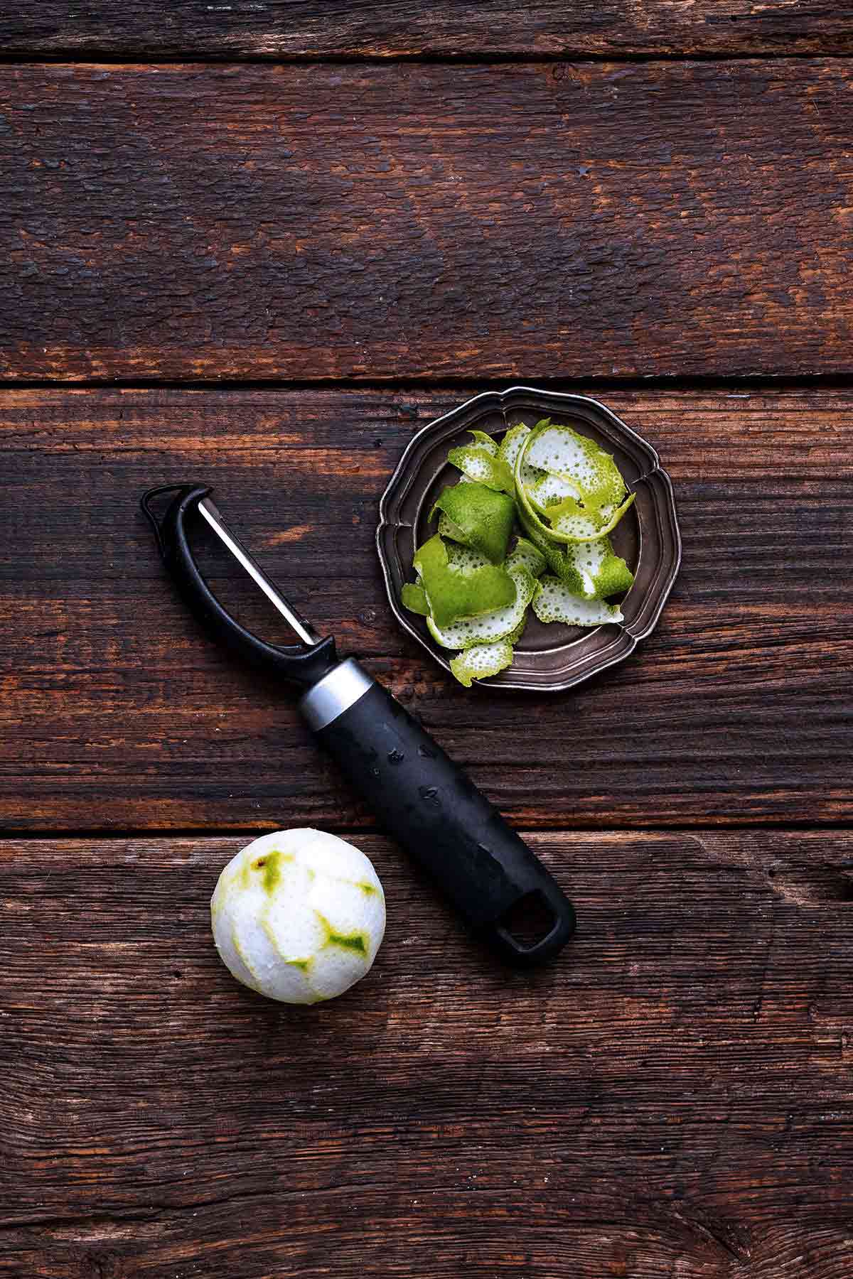 fresh lemon peel on vintage silver plate on dark wooden table