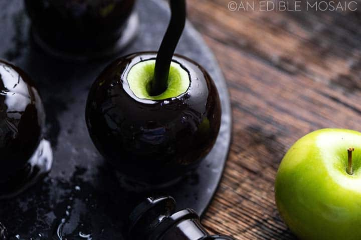 green poison apple on black tray