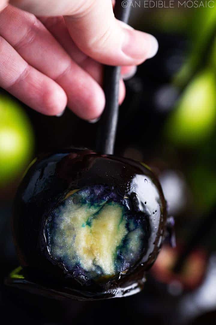 hand holding poison apple with bite
