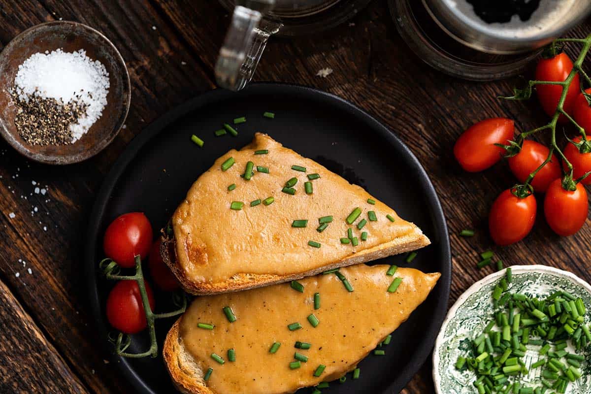 overhead view of plated welsh rarebit with a pint of ale