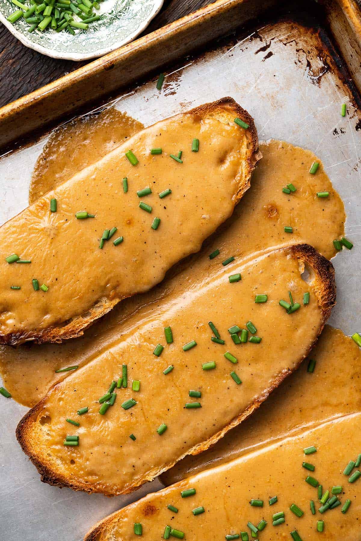 top view of welsh rarebit meal topped with chives