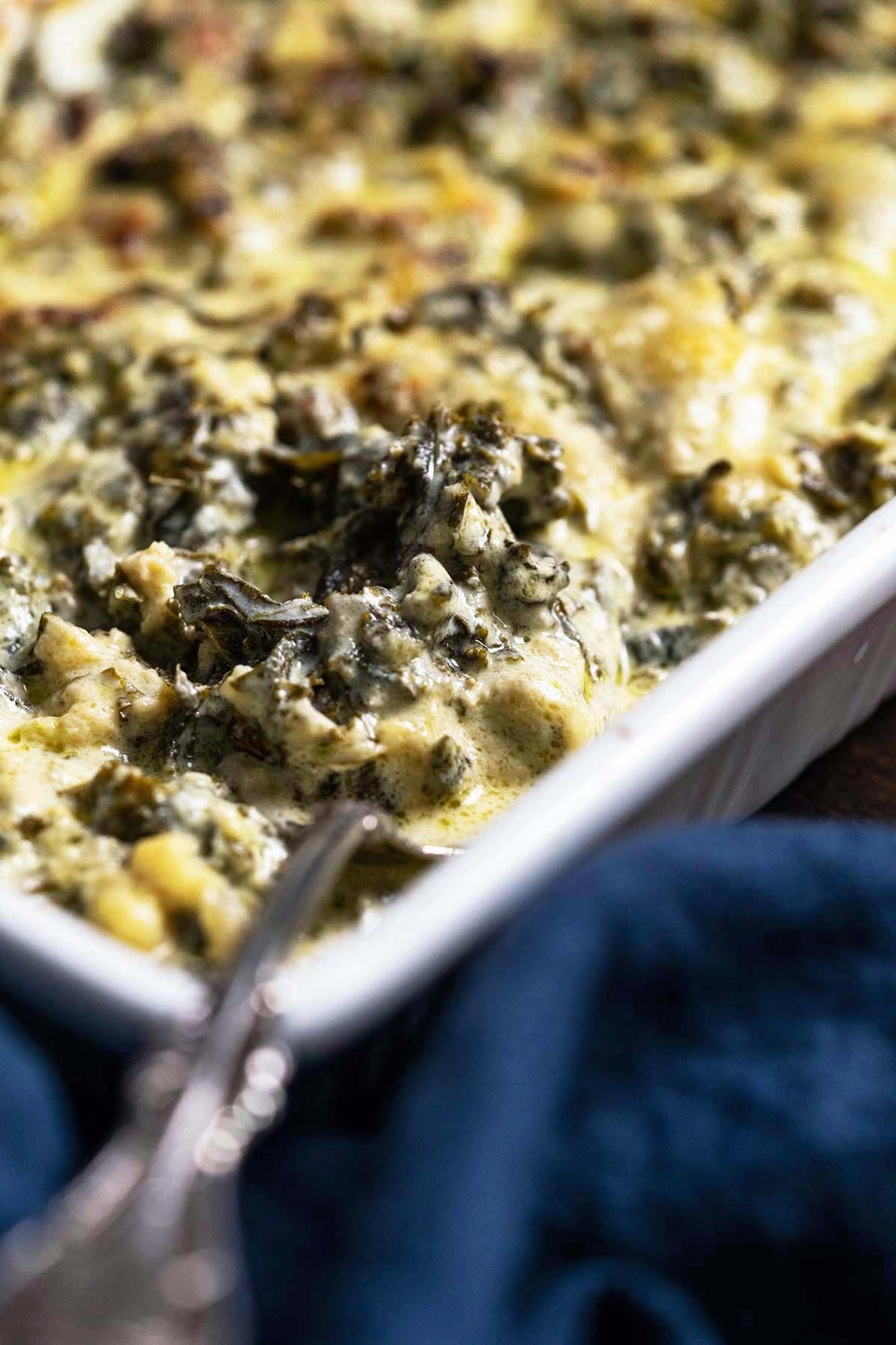 close up of healthy kale gratin in casserole dish
