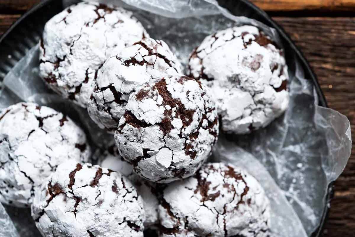 close up top view of plate of chocolate crinkle cookies