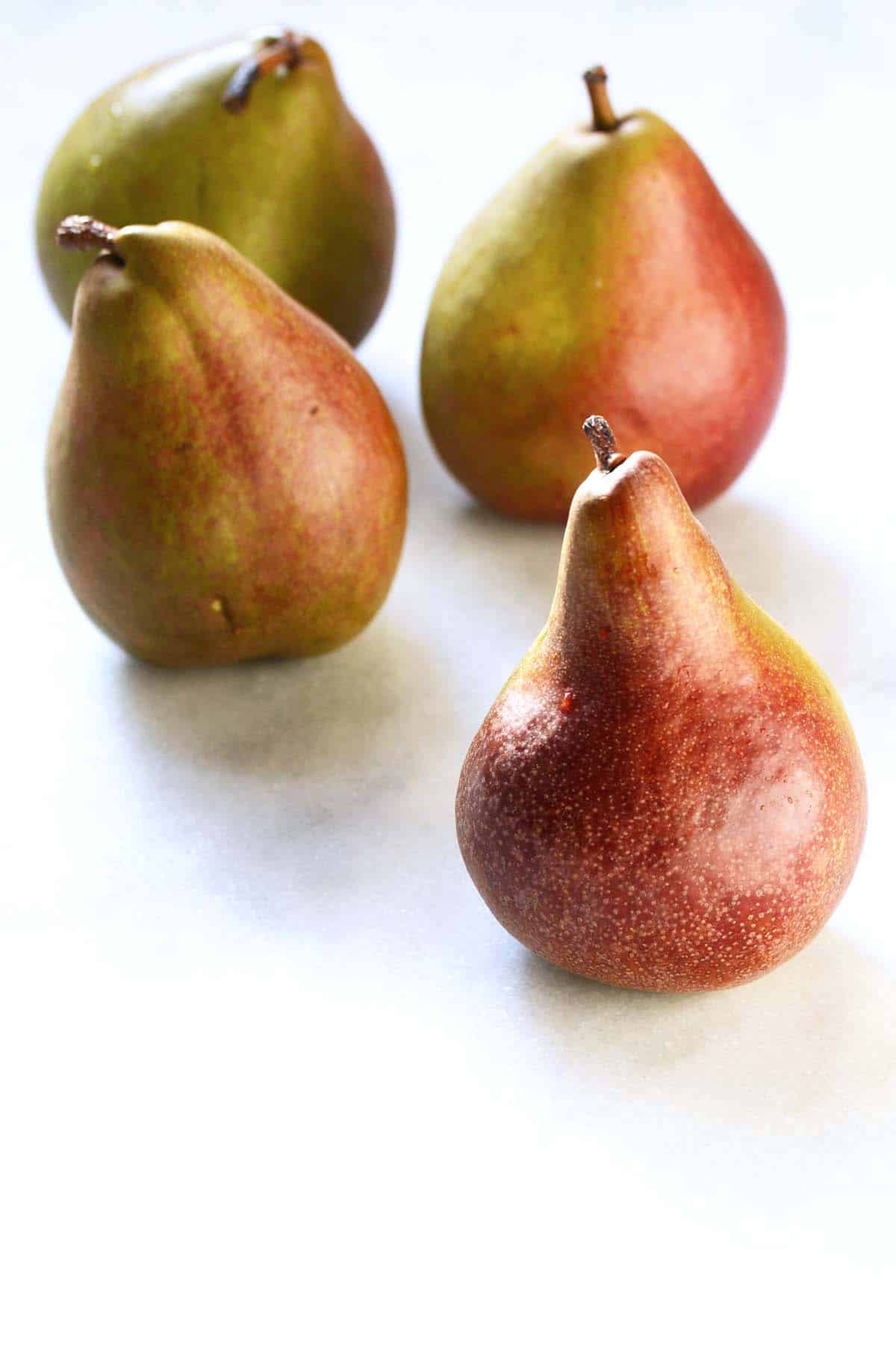 fresh red pears on marble countertop