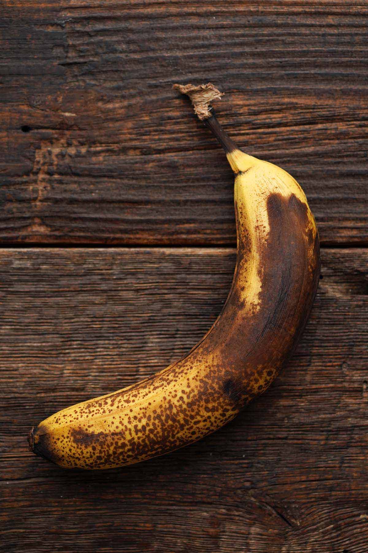 overripe banana on dark wooden table