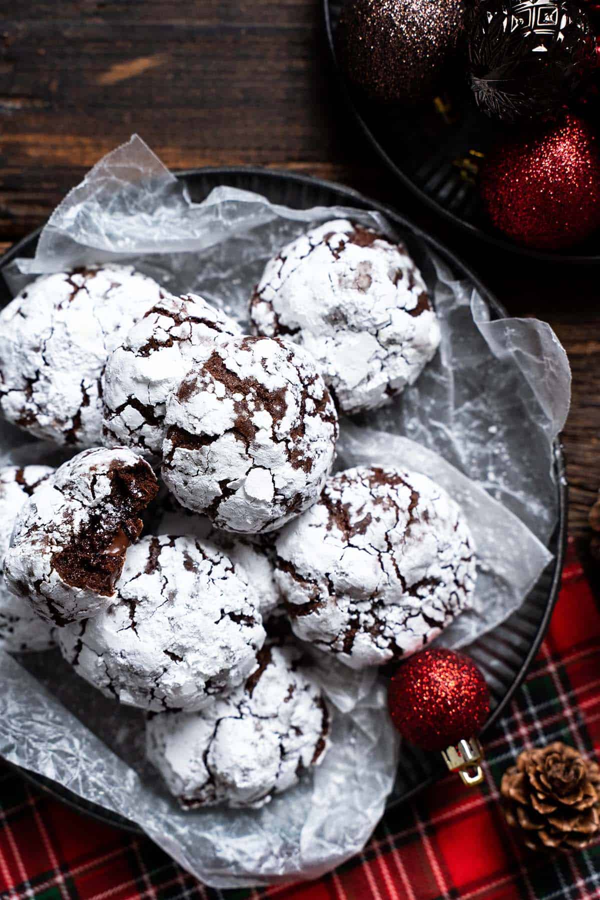 plate of chocolate cookies with festive christmas ornaments around