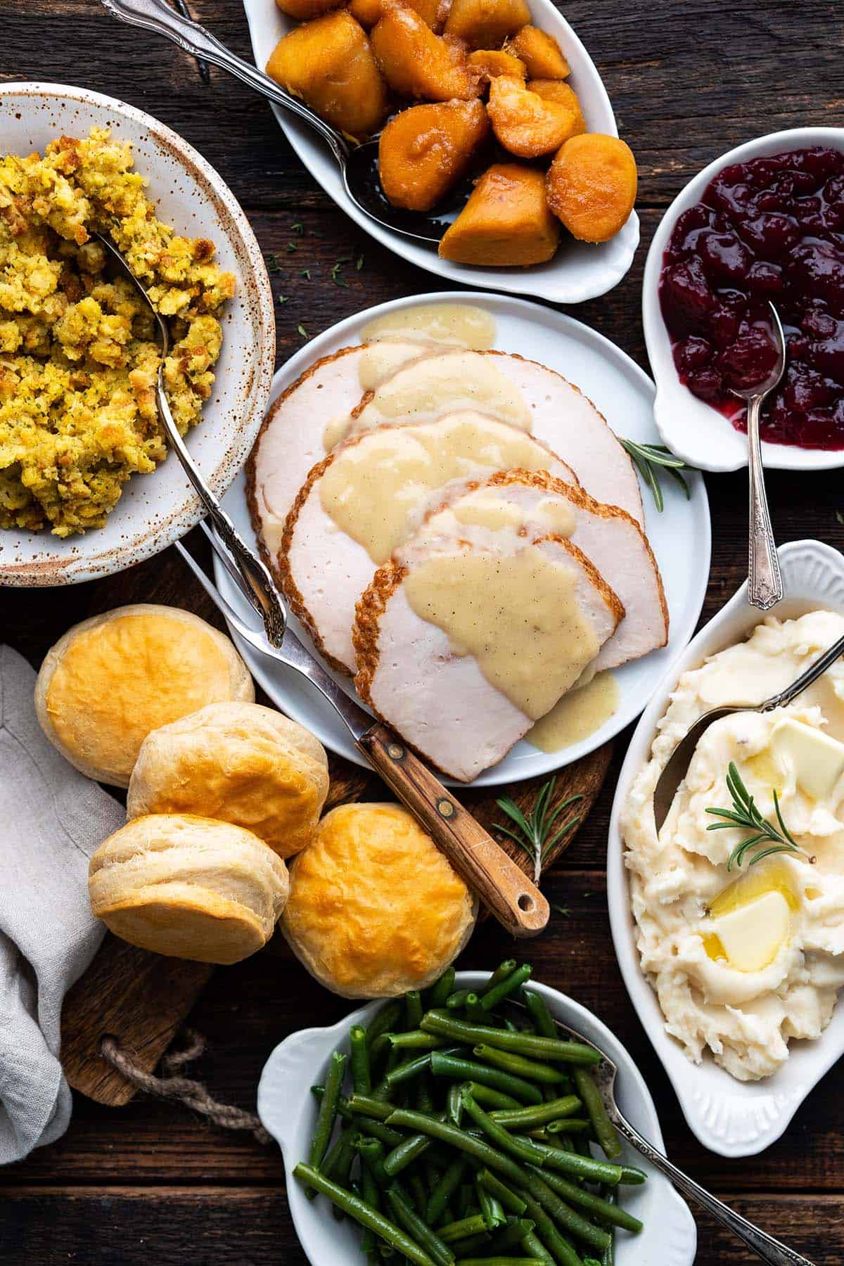 spread of easy thanksgiving dinner with convenience items on wooden table