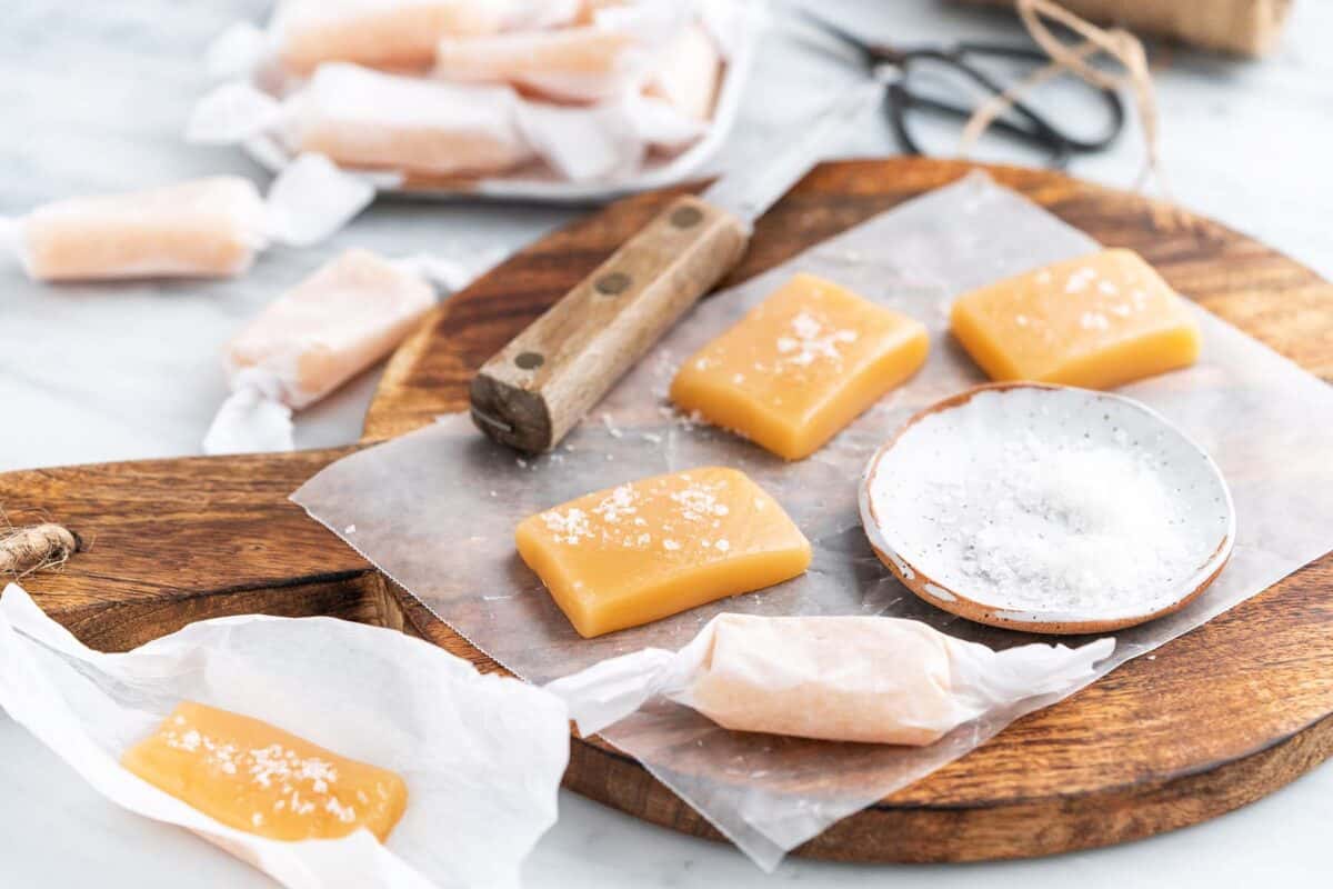 front view of salted caramels on board with dish of sea salt