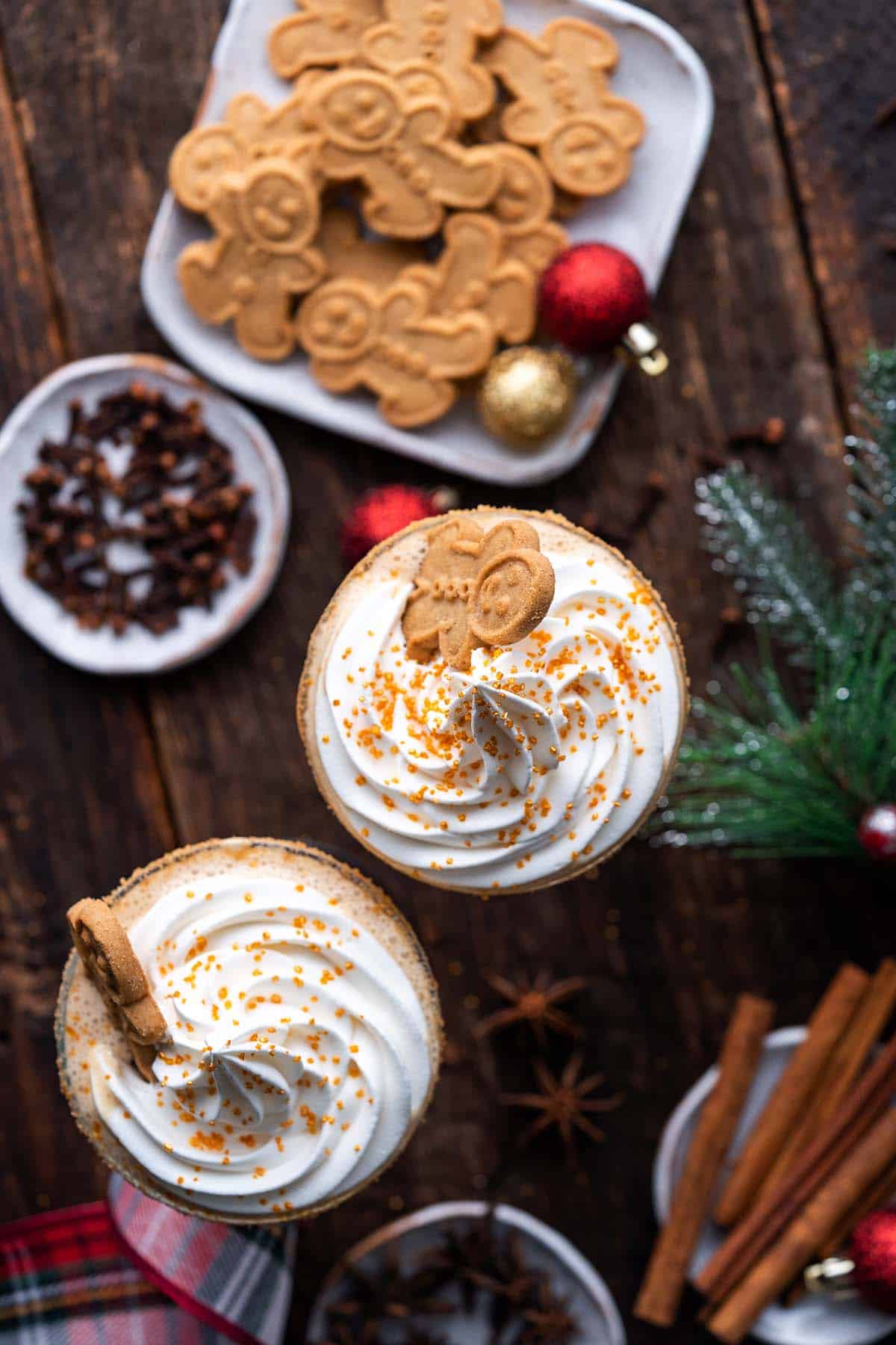 frozen gingerbread cocktails on wooden table with festive decorations