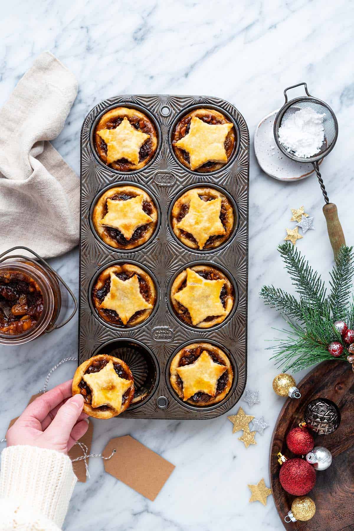 hand removing mince tart from tart of tarts