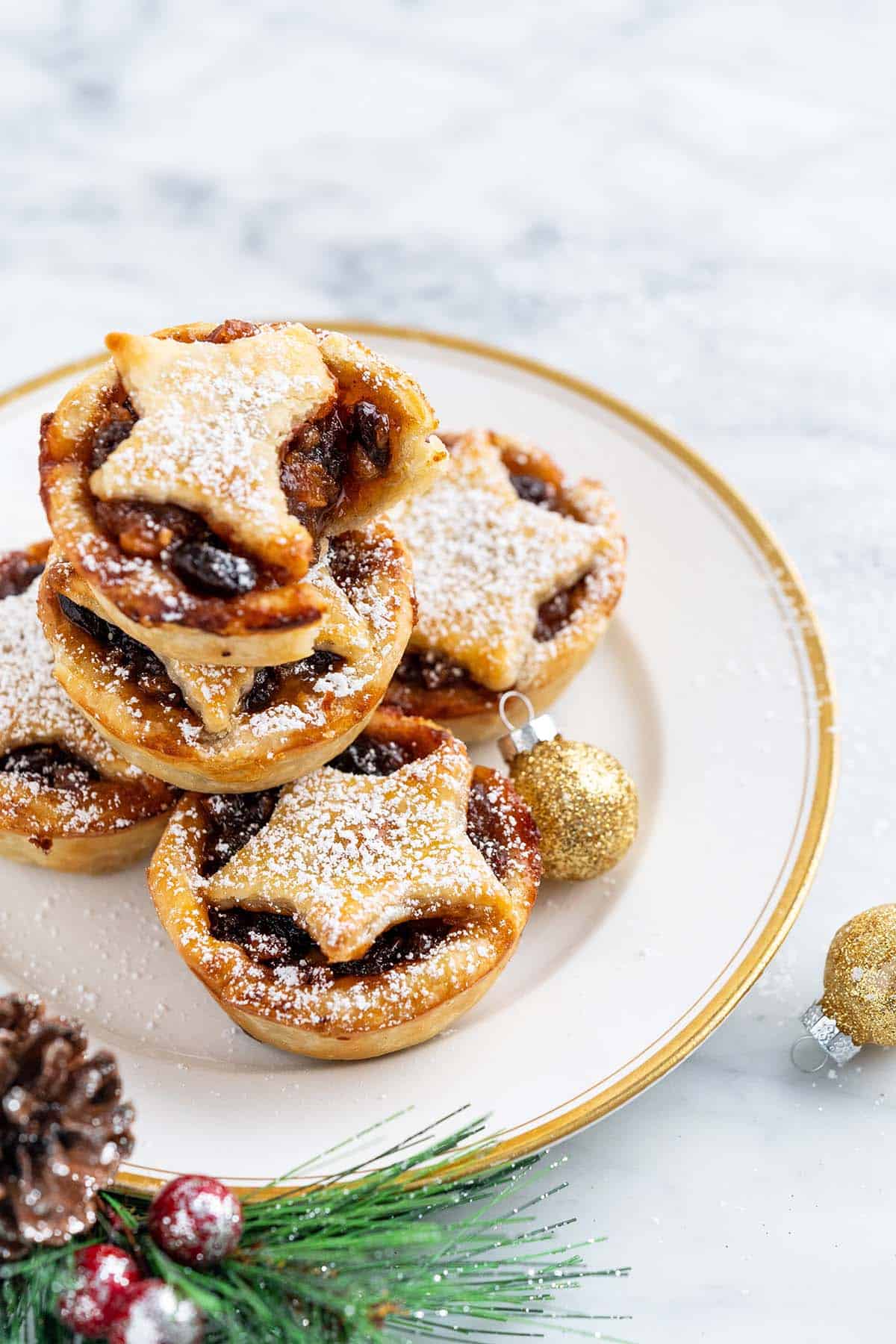plate of stacked mincemeat tarts with bite in top tart