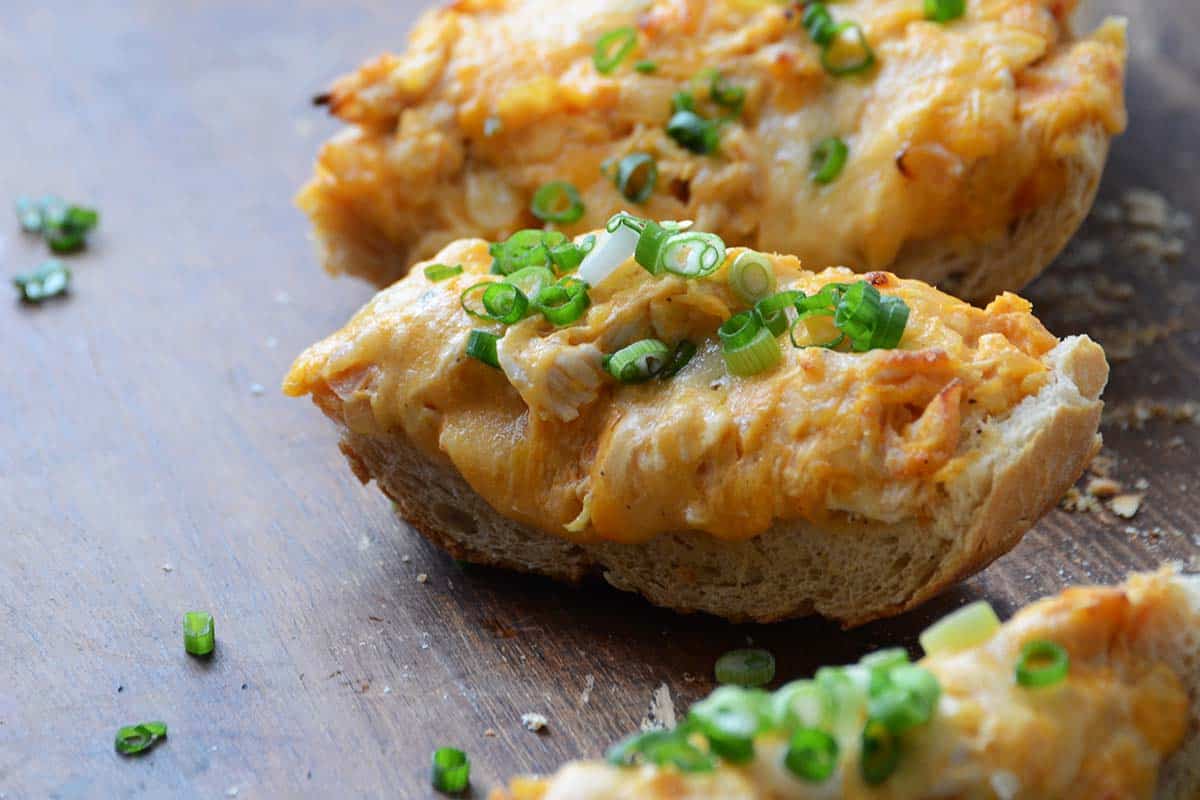 side view of slice of cheesy spicy chicken french bread pizza