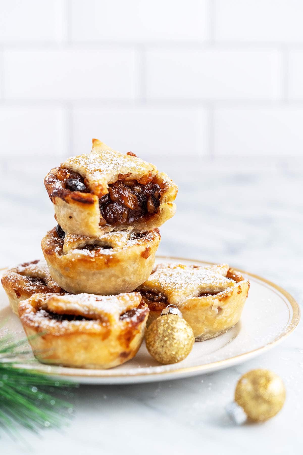 stack of mince tarts on gold rimmed plate