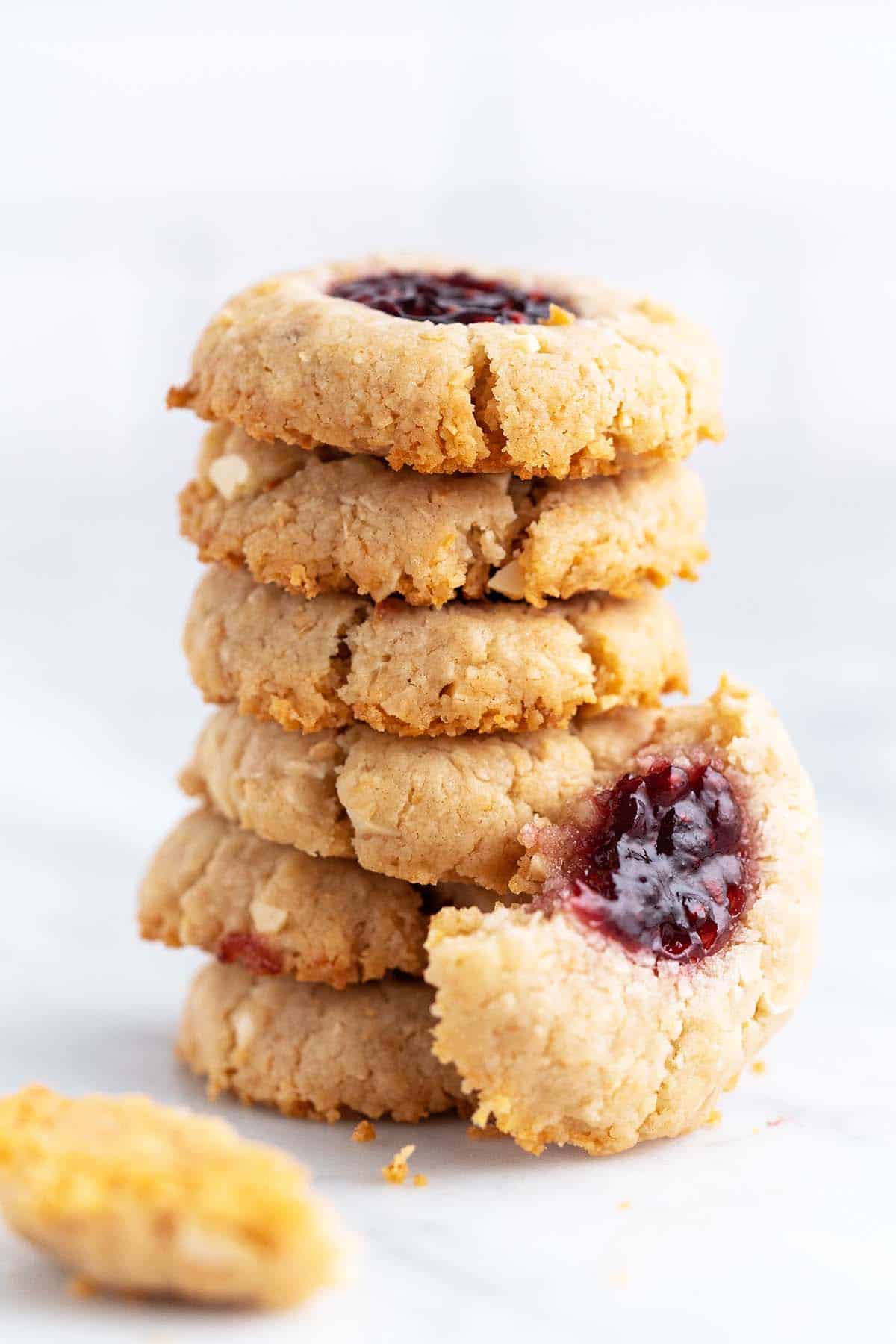 stack of vegan thumbprint cookies with jam